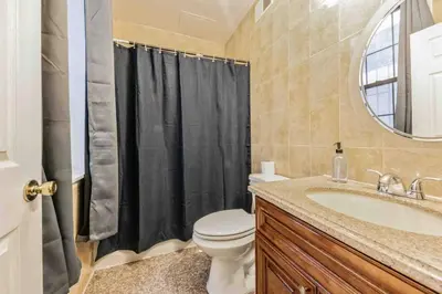 a bathroom with a toilet and a sink and a mirror at Cozy Studio Across from Convention Center - 3R in Philadelphia