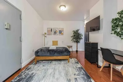 a bedroom with a bed and a desk in it at Cozy Studio Across from Convention Center - 3R in Philadelphia
