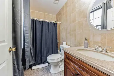 a bathroom with a sink and a toilet and a mirror at Cozy Studio Across from Convention Center - 3R in Philadelphia