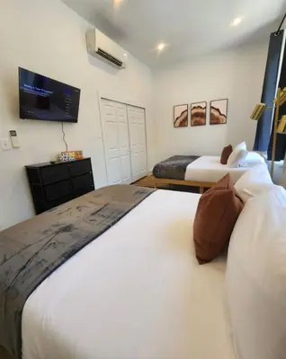 a bedroom with two beds and a flat screen tv at Renovated Jr 1BR - Center City - Sleeps 4 - 2 Beds in Philadelphia