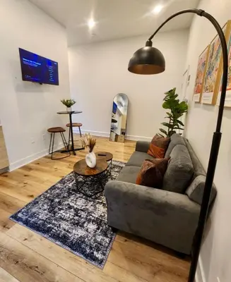 a living room with a couch and a table at Renovated Jr 1BR - Center City - Sleeps 4 - 2 Beds in Philadelphia