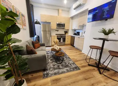 a living room with a couch and a kitchen at Renovated Jr 1BR - Center City - Sleeps 4 - 2 Beds in Philadelphia