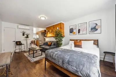 a bedroom with a bed and a living room at Charming Studio in the Heart of Center City with Fast WiFi in Philadelphia