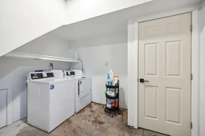 a white laundry room with a washer and dryer at Charming Studio in the Heart of Center City with Fast WiFi in Philadelphia