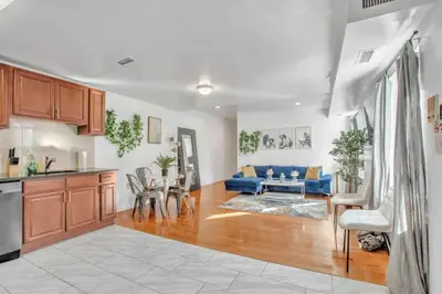 a kitchen and living room with a blue couch at Large 3BR in Spring Garden in Philadelphia