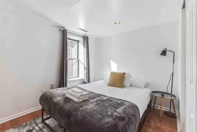 a white bedroom with a bed and a window at Large 3BR in Spring Garden in Philadelphia