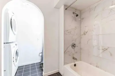 a white bathroom with a tub and a sink at Large 3BR in Spring Garden in Philadelphia