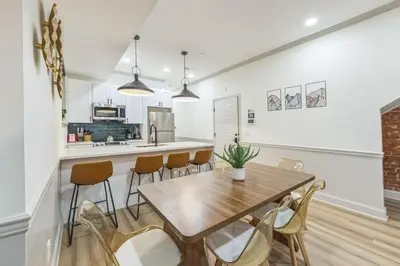 a kitchen and dining room with a wooden table and chairs at New 2BR Across from Fairmount Park - 10 mins to DT in Philadelphia
