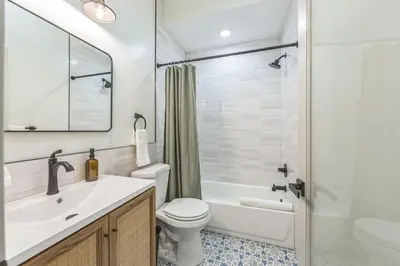 a bathroom with a sink and a toilet and a tub at New 2BR Across from Fairmount Park - 10 mins to DT in Philadelphia