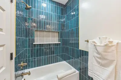 a bathroom with blue tiled walls and a bath tub at New 2BR Across from Fairmount Park - 10 mins to DT in Philadelphia