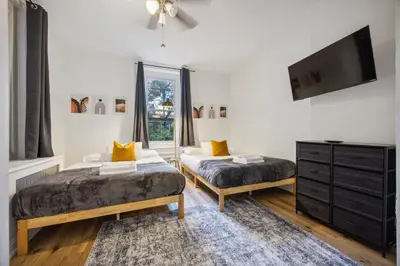 a bedroom with two beds and a tv on the wall at Quaint and Cozy Center City 1BR that Sleeps 4 in Philadelphia