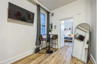a living room with a mirror and a table at Quaint and Cozy Center City 1BR that Sleeps 4 in Philadelphia
