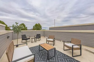a patio with chairs and tables on a building at Bi-Level 2BR w Rooftop - Sleeps 12 - 10 min to DT in Philadelphia