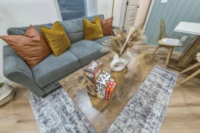 a living room with a couch and a coffee table at Bi-Level 2BR w Rooftop - Sleeps 12 - 10 min to DT in Philadelphia