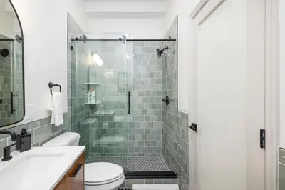 a bathroom with a shower with a toilet and a sink at 1BR Across from Fairmount Park - 10 mins to DT (E) in Philadelphia