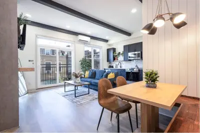 a living room with a blue couch and a table at 1BR Across from Fairmount Park - 10 mins to DT (E) in Philadelphia