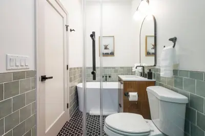 a bathroom with a tub and a toilet and a sink at 1BR Across from Fairmount Park - 10 mins to DT (E) in Philadelphia