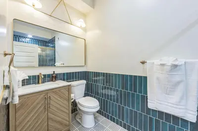 a bathroom with a toilet and a sink and a mirror at New 2BR Across from Fairmount Park - 10 Mins to DT in Philadelphia
