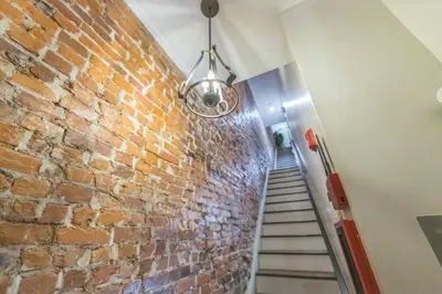 a staircase with a brick wall and a light at New 2BR Across from Fairmount Park - 10 Mins to DT in Philadelphia