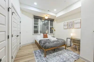 a bedroom with a bed and a desk and a window at New 2BR Across from Fairmount Park - 10 Mins to DT in Philadelphia