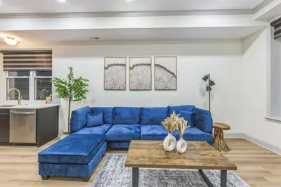 a blue couch in a living room with a table at New 2BR Across from Fairmount Park - 10 Mins to DT in Philadelphia