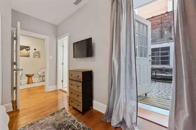 a room with a dresser and a television and a window at NEW 4 Bedroom - 4 Bathroom Center City with Private Rooftop Terrace Sleeps 20) in Philadelphia