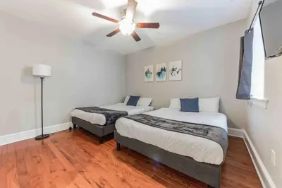 a bedroom with two beds and a ceiling fan at NEW 4 Bedroom - 4 Bathroom Center City with Private Rooftop Terrace Sleeps 20) in Philadelphia