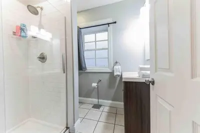 a white bathroom with a shower and a sink at NEW 4 Bedroom - 4 Bathroom Center City with Private Rooftop Terrace Sleeps 20) in Philadelphia