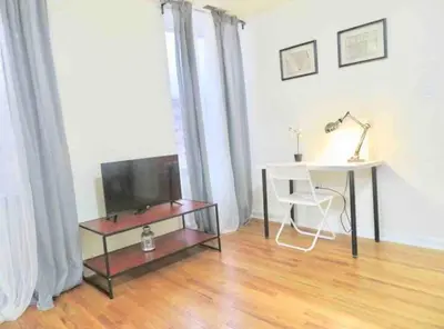 a living room with a table and a tv and a desk at In the heart of Center City - Large bi-level 3BR in Philadelphia