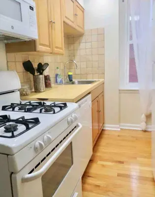 a white stove top oven in a kitchen at In the heart of Center City - Large bi-level 3BR in Philadelphia