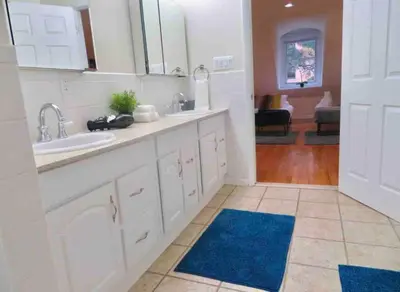a kitchen with white cabinets and a blue rug at In the heart of Center City - Large bi-level 3BR in Philadelphia