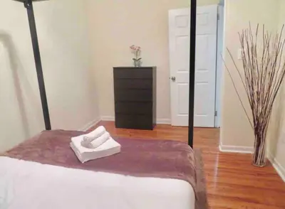 a bedroom with a bed and a dresser with a towel at In the heart of Center City - Large bi-level 3BR in Philadelphia