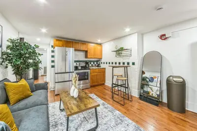 a living room with a couch and a table at Cozy Center City 1BR apartment with Patio in Philadelphia