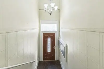 a hallway with a door and a chandelier at Cozy Center City 1BR apartment with Patio in Philadelphia