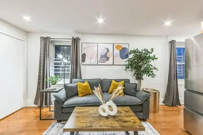 a living room with a couch and a table at Cozy Center City 1BR apartment with Patio in Philadelphia