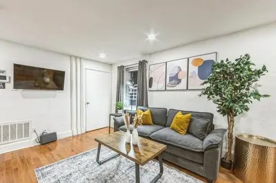a living room with a couch and a table at Cozy Center City 1BR apartment with Patio in Philadelphia