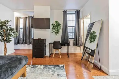 a room with a bed and a table and chairs at Studio Across the Street from Convention Center 2R in Philadelphia