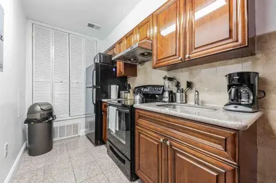 a kitchen with a sink and a stove and refrigerator at Studio Across the Street from Convention Center 2R in Philadelphia