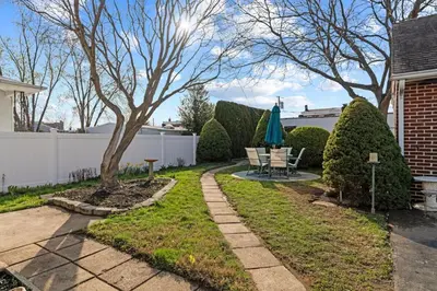 a patio with a tree and a table and chairs at Historic Tacony Retreat with Sauna in Philadelphia