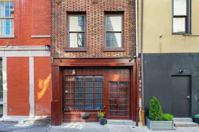 a red brick building with a large garage at Charming Home in Vibrant Philadelphia in Philadelphia