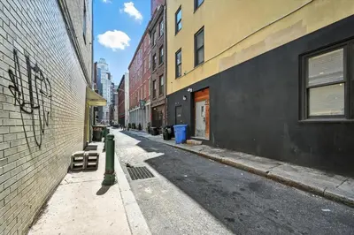 an empty street in a city with buildings at Charming Home in Vibrant Philadelphia in Philadelphia