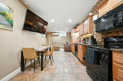a kitchen with a table and chairs in a room at Charming Home in Vibrant Philadelphia in Philadelphia