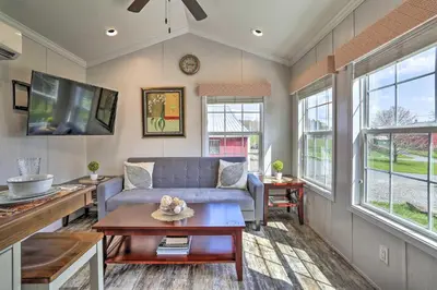 a living room with a couch and a tv at Forest Hideout Cottage Close to Camps and Ski Resorts in Pleasant Mount