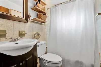 a bathroom with a white toilet and a sink at Tranquil Trails Cottage Fire Pit Cozy 3BDR in Gouldsboro