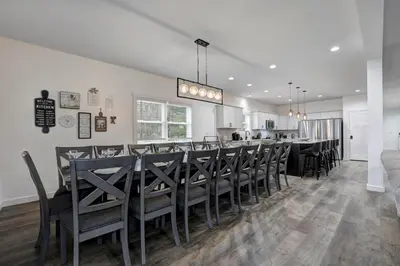 a dining room with a long table and chairs at New Lakeview Gateway Lake Access, Hot tub, EV in Lake Harmony