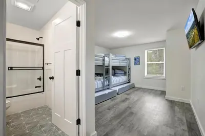 a room with two bunk beds and a television at New Lakeview Gateway Lake Access, Hot tub, EV in Lake Harmony