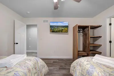a bedroom with two beds and a book shelf at New Lakeview Gateway Lake Access, Hot tub, EV in Lake Harmony
