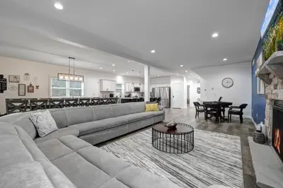 a large living room with a couch and a table at New Lakeview Gateway Lake Access, Hot tub, EV in Lake Harmony