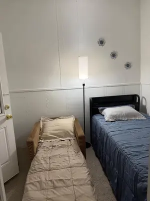 a room with two beds and a bedskirts at Cozy Comfy with AMAZING NYC Views 15min to Manhattan T SQ in Union City