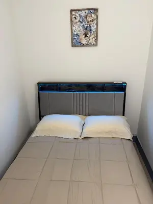 a bed in a room with a picture on the wall at Cozy Comfy with AMAZING NYC Views 15min to Manhattan T SQ in Union City